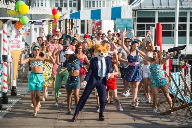 A TV ad promotion for Foxy Bingo featuring Foxy and his friends dancing on Brighton Pier to a remix of Get Happy! by Judy Garland.